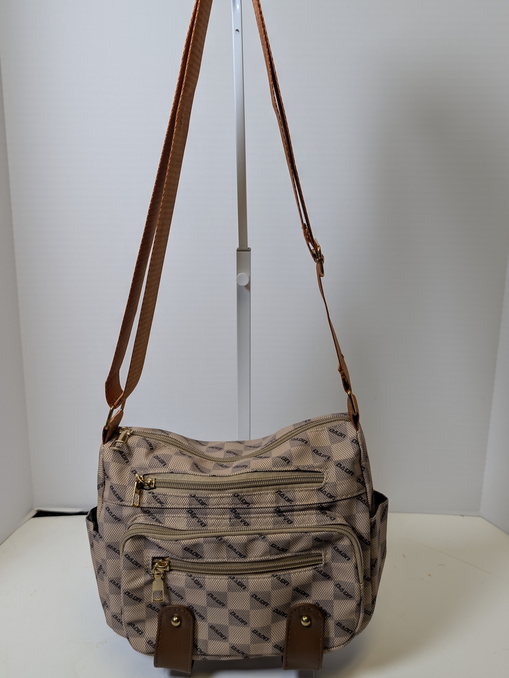 Beige Patterned Crossbody Bag with Brown Strap and Gold Accents
